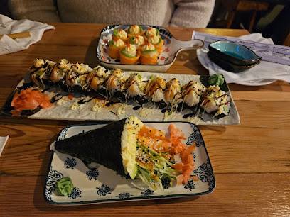 Sushi Wave Bar assorted sushi rolls and salmon temaki on wooden table