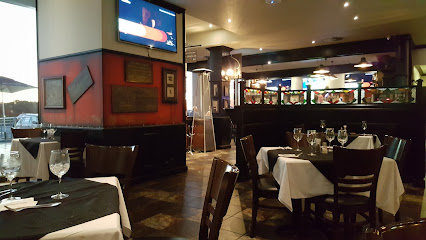 The Brazen Head Big Bay pub interior with white-tablecloth dining tables and bar