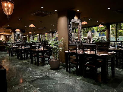 Haiku Cape Town CBD dining room with wooden tables, hanging lanterns, and potted plants