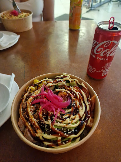 Nihao Kitchen Asian fusion bowl with sauce drizzles, pickled onions and Coca-Cola can