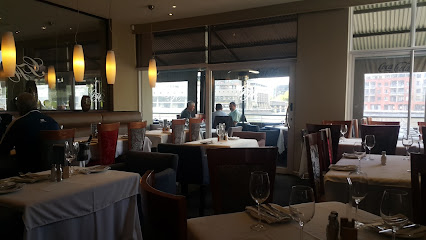 Cattle Baron Tyger Waterfront dining room with set tables and waterfront view