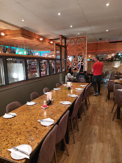 Petiscos dining room with a long communal table set for guests