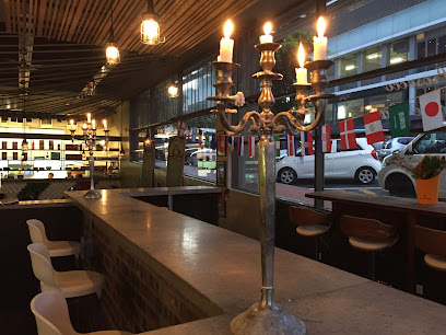 Step Brothers Restaurant and Bar interior with candlelit candelabra and street-facing counter seating