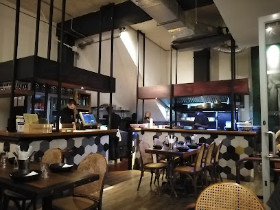 Sundoo Newlands dining area with tables, bar and open kitchen