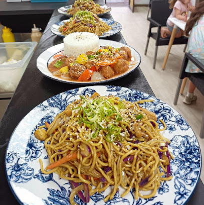 Sushi House counter with plated noodles, rice and saucy dishes