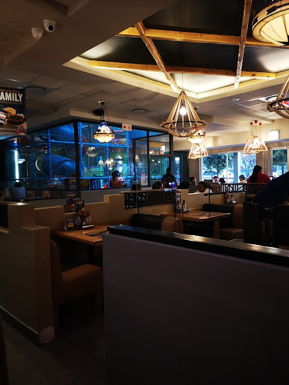 Silver Creek Spur dining area with booths and warm pendant lighting