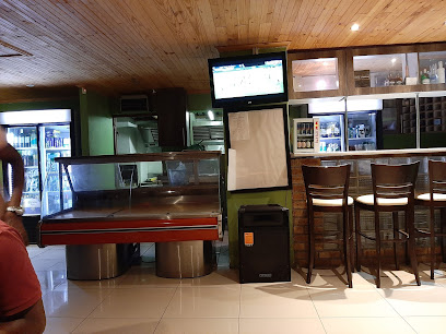 Cafe Ngova Pub & Grill interior with bar counter, high stools and TV