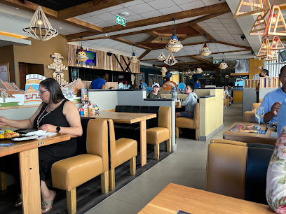 Santa Monica Spur dining room with booths, pendant lights and diners