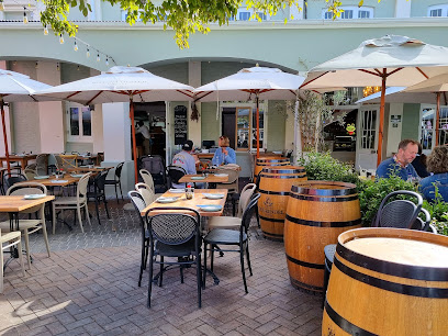 Knysna Oyster Company V&A Waterfront outdoor patio with umbrellas and barrels