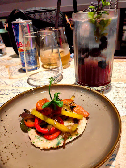 Spyced Restaurant plated roasted peppers on flatbread with berry cocktail