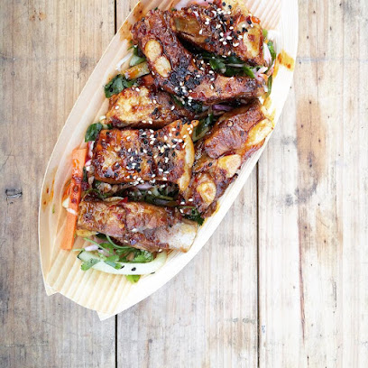 Lotus Food Truck glazed sesame rolls on pickled veg in wooden tray