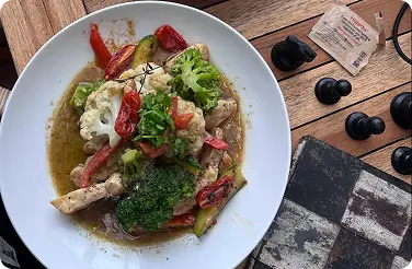 Hearty chicken stew with roasted vegetables and fresh parsley garnish